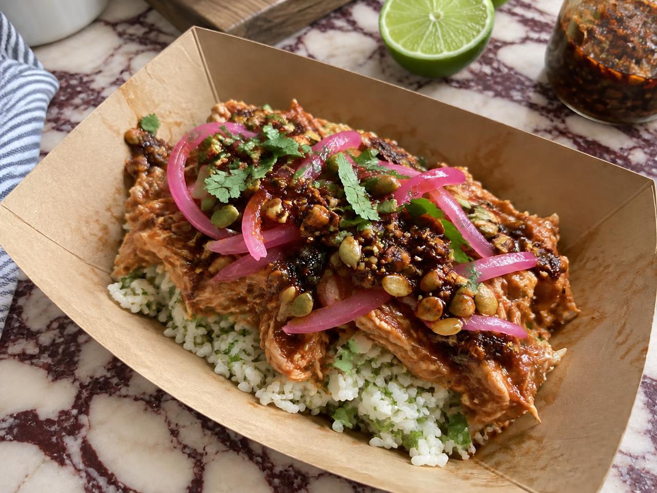 Chicken tinga over lime rice with pepita salsa macha and pickled onions